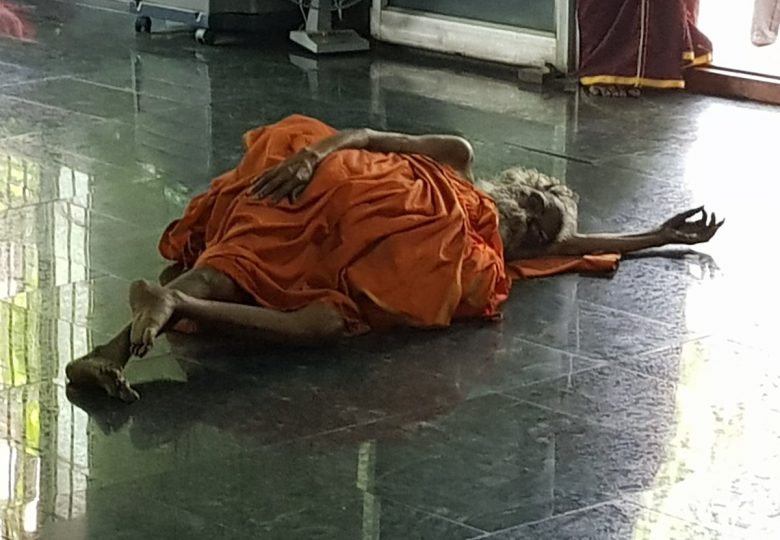 muoku podi swami laying on floor in meditation hall at sheshadri ashram