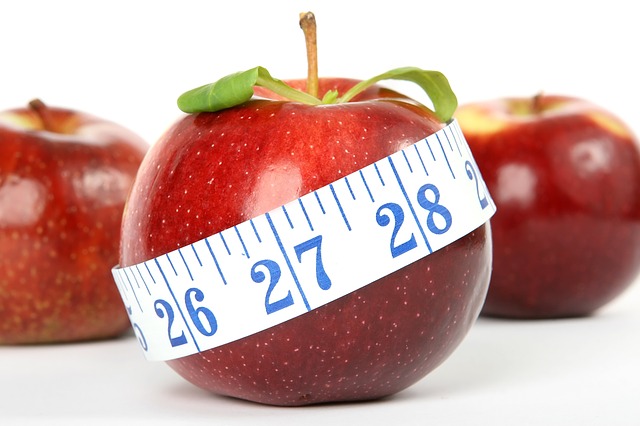 red apples with measuring tape