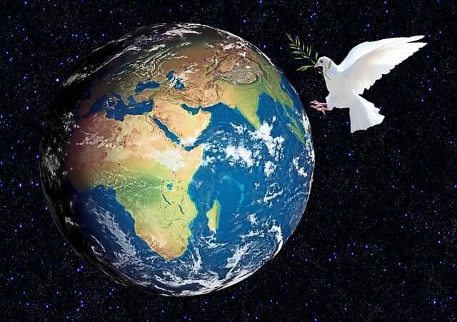white dove with olive branch and planet Earth as symbol for world peace