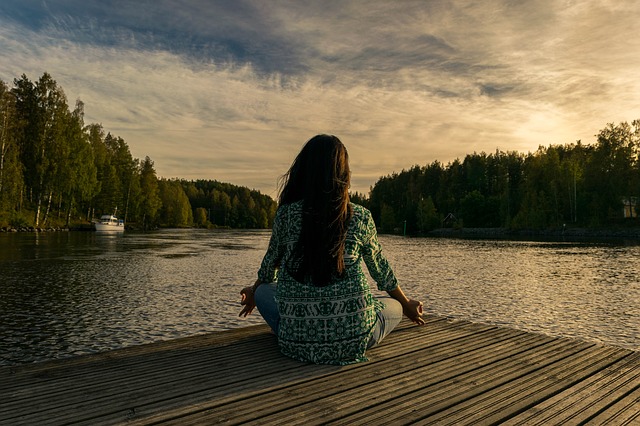 woman in meditation at lake